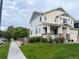 Charming two-story home with a well-maintained lawn, landscaped yard, and a covered front porch at 12196 Helena St, Commerce City, CO 80603