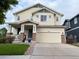 Charming two-story home with a welcoming front porch and well-maintained lawn at 12196 Helena St, Commerce City, CO 80603