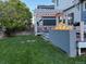 A backyard view showcasing a charming pergola extending over an outdoor fire pit and patio area at 12196 Helena St, Commerce City, CO 80603