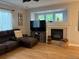 Inviting living room with a cozy fireplace, entertainment center, and comfortable seating at 12196 Helena St, Commerce City, CO 80603