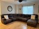Comfortable living room with a plush sectional sofa and well-lit ambiance at 12196 Helena St, Commerce City, CO 80603