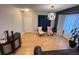 Bright living room with hardwood floors, elegant light fixture, and comfortable seating arrangement at 12196 Helena St, Commerce City, CO 80603