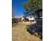 Expansive backyard features a play set, treehouse, and lush lawn, ideal for outdoor activities at 1051 Jasper St, Aurora, CO 80011