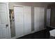 Bedroom featuring multiple storage closets with traditional style doors, and dark wood floors at 1051 Jasper St, Aurora, CO 80011