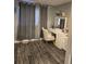 Bedroom featuring gray walls, vinyl flooring, a makeup vanity, and neutral colored curtains at 1051 Jasper St, Aurora, CO 80011