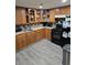 Classic kitchen with wooden cabinets, modern appliances, and durable gray flooring at 1051 Jasper St, Aurora, CO 80011