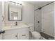 Updated bathroom with white vanity, black hardware, and a tiled walk-in shower at 7752 Meade St, Westminster, CO 80030