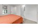 Bright bedroom features neutral carpet, en suite bathroom, and a large window at 7752 Meade St, Westminster, CO 80030