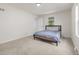Bedroom with neutral carpet, modern bed frame, and a window overlooking the yard at 7752 Meade St, Westminster, CO 80030