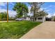 Curb view of a well-kept home with a large front yard, driveway, and mature trees at 7752 Meade St, Westminster, CO 80030