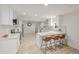 Updated kitchen features white cabinets, modern appliances, ample counter space, and breakfast bar at 7752 Meade St, Westminster, CO 80030