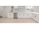 Updated kitchen features modern appliances, white cabinets, and stylish backsplash at 7752 Meade St, Westminster, CO 80030