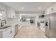 Spacious, renovated kitchen with stainless steel appliances, light wood floors, and white cabinets at 7752 Meade St, Westminster, CO 80030