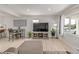 Cozy living room with ample natural light, dining area, and sleek entertainment setup at 7752 Meade St, Westminster, CO 80030