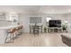 Bright and airy dining and living space with modern decor and light-colored flooring at 7752 Meade St, Westminster, CO 80030