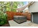 Backyard showcasing a modern gray hot tub covered by a sail shade near wooden fence at 4643 S Vrain St, Denver, CO 80236