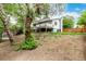 Backyard showcasing a spacious yard, mature trees, and a raised deck at 4643 S Vrain St, Denver, CO 80236