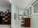 An entrance to the bathroom that includes a double vanity, new fixtures, and tile flooring at 4643 S Vrain St, Denver, CO 80236