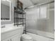 Bathroom with white vanity, toilet, and a shower/tub combo with sliding glass doors at 4643 S Vrain St, Denver, CO 80236