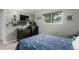 Bedroom features a large window, dark dressers, display shelf, and fun patterned bedding at 4643 S Vrain St, Denver, CO 80236