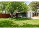 Charming home featuring a welcoming front yard with mature trees and a seating area at 4643 S Vrain St, Denver, CO 80236