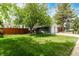 Charming home featuring a welcoming front yard with mature trees and a seating area at 4643 S Vrain St, Denver, CO 80236
