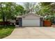 Charming home featuring an attached two-car garage, a driveway, and a well-maintained front yard with mature trees at 4643 S Vrain St, Denver, CO 80236