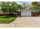 Charming home featuring an attached two-car garage, a driveway, and a well-maintained front yard with mature trees at 4643 S Vrain St, Denver, CO 80236