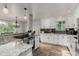 Bright kitchen featuring white cabinets, granite countertops, and modern stainless steel appliances at 4643 S Vrain St, Denver, CO 80236