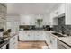 Well-lit kitchen featuring white cabinets, granite countertops, and stainless steel appliances at 4643 S Vrain St, Denver, CO 80236