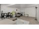Spacious living room with carpet, couch, and storage shelves, perfect for relaxing and entertaining at 4643 S Vrain St, Denver, CO 80236