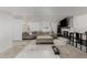 Cozy living room with a large couch, ottoman, and TV over the fireplace; perfect for relaxing at 4643 S Vrain St, Denver, CO 80236