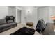 Small office with a gray futon, neutral walls, and a black faux fur rug at 4643 S Vrain St, Denver, CO 80236