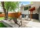 A home's outdoor patio space showcases seating and mature trees, perfect for relaxing at 4643 S Vrain St, Denver, CO 80236