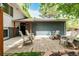 A home's outdoor patio space showcases seating and mature trees, perfect for relaxing at 4643 S Vrain St, Denver, CO 80236