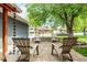 A home's outdoor patio space showcases seating and mature trees, perfect for relaxing at 4643 S Vrain St, Denver, CO 80236