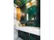 Elegant bathroom with a herringbone tile wall, a marble vanity, and stylish fixtures at 3355 E Eastman Ave, Denver, CO 80210