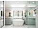 Bright bathroom with white tub under a skylight, surrounded by vanity, mirrors, and glass enclosed shower at 3355 E Eastman Ave, Denver, CO 80210
