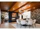 Elegant dining area featuring a black brick fireplace, unique light fixture, and a round table with seating for eight at 3355 E Eastman Ave, Denver, CO 80210