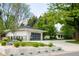 Stunning exterior view of home with white brick, black garage door, and professional landscaping at 3355 E Eastman Ave, Denver, CO 80210