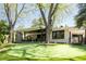 Exterior of home with brick and views of the back yard featuring a putting green at 3355 E Eastman Ave, Denver, CO 80210