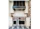 Close-up of a kitchen with a high-end Wolf range and custom hood, perfect for cooking enthusiasts at 3355 E Eastman Ave, Denver, CO 80210