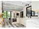 Well-lit kitchen with stainless appliances, marble counters, black-and-white floors, and wine storage at 3355 E Eastman Ave, Denver, CO 80210
