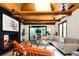 Sunlit living room featuring a unique fireplace, exposed wooden beams, and a plush sectional sofa with decorative pillows at 3355 E Eastman Ave, Denver, CO 80210