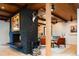 Modern living room showcasing a black brick fireplace, wooden beams, and stylish mid-century modern furniture at 3355 E Eastman Ave, Denver, CO 80210