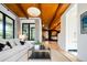 Inviting living room showcasing the beautiful wood ceiling and seamlessly connecting to the kitchen at 3355 E Eastman Ave, Denver, CO 80210