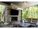 Outdoor living area featuring a brick fireplace with television and comfortable seating at 3355 E Eastman Ave, Denver, CO 80210