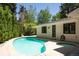 Backyard pool and jacuzzi with clear water and surrounded by manicured lawn at 3355 E Eastman Ave, Denver, CO 80210