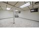 A large finished basement with paneled walls, neutral carpet, and abundant lighting at 8364 Allison Ct, Arvada, CO 80005