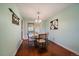 Bright dining room features hardwood floors, a modern chandelier, and sliding glass doors at 8364 Allison Ct, Arvada, CO 80005